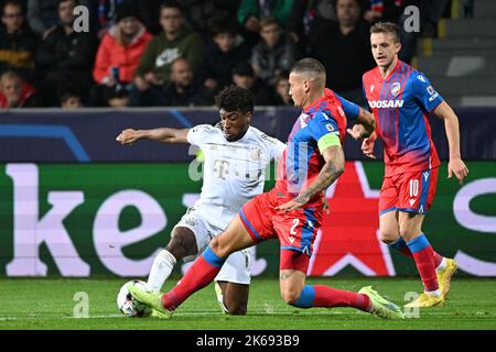 Pilsen, Czech Republic. 12th Oct, 2022. L-R Kingsley Coman of Bayern and Lukas Hejda and Jan Kopic of Pilsen in action during the Viktoria Plzen vs Bayern Munich group C of football Champions' League match in Pilsen, Czech Republic, October 12, 2022. Credit: Michal Kamaryt/CTK Photo/Alamy Live News Stock Photo