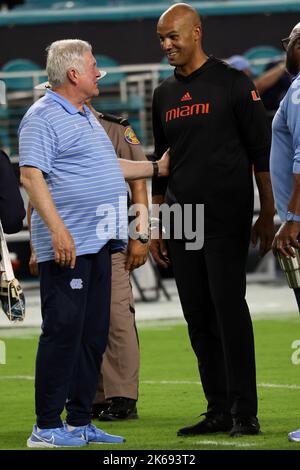 North Carolina Tar Heels head coach Mack Brown and Miami Hurricanes off-field analyst and Pro Football Hall of Famer Jason Taylor talk after the game at Hard Rock Stadium on October 8, 2022 in Miami Gardens, FL.  North Carolina Tar Heels defeated Miami Hurricanes 27-24 (Credit: Paul Fong/Image of Sport) Stock Photo