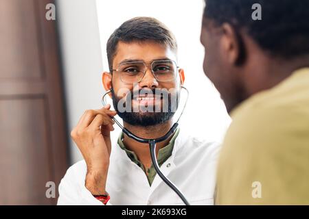 Indian doctor therapist in white coat consulting supporting patient in ...