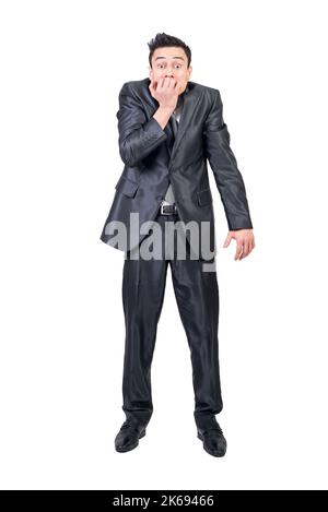 Nervous businessman biting nails in studio. White background. Stock Photo
