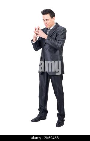 Scheming businessman looking at camera in studio Stock Photo