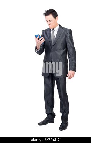 Worried man in suit reading message on smartphone Stock Photo