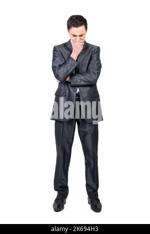 Preoccupied man in formal suit touching chin Stock Photo