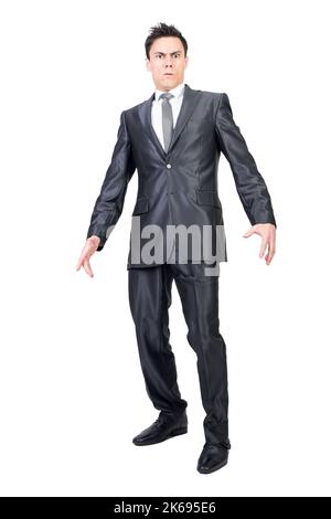 Surprised young businessman standing in studio and looking at camera Stock Photo