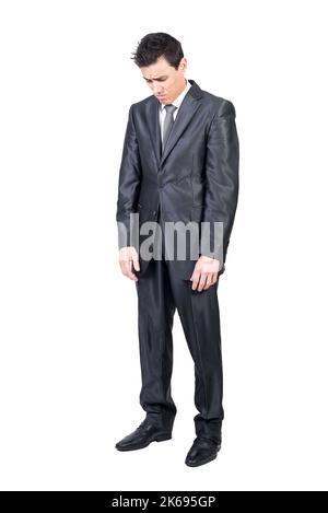 Sad young male manager looking down in white studio Stock Photo