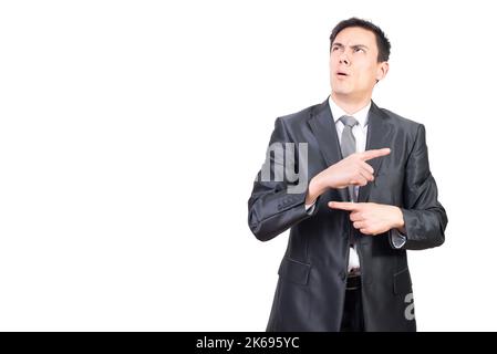 Young embarrassed businessman looking away thoughtfully in studio Stock Photo