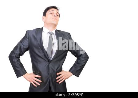 Confident businessman standing in studio with hands on waist Stock Photo
