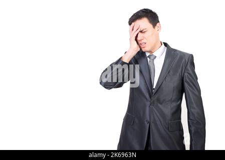 Tired man in suit suffering from headache Stock Photo