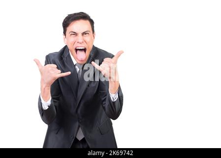Excited man in black suit showing rock gesture Stock Photo