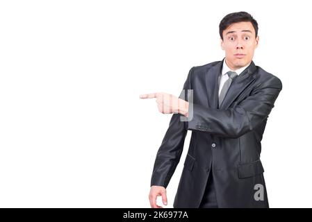 Confident young businessman pointing aside with surprise Stock Photo