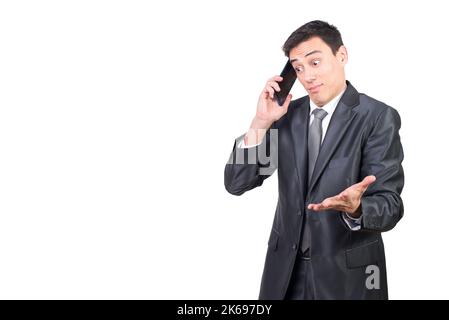 Confused man in suit talking on smartphone Stock Photo