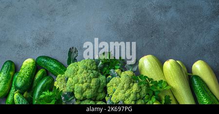 Assortment of fresh vegetables and herbs on a dark background. Stock Photo