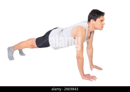 Strong sportsman doing push ups in studio Stock Photo