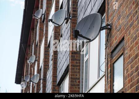 Satellite dishes on a wall of residential block, London, England United Kingdom UK Stock Photo