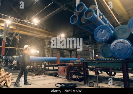Shipment of metal pipes for gas pipeline or water in factory floor. Stock Photo