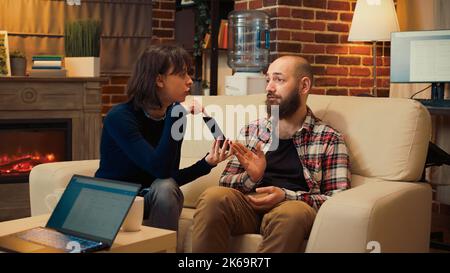 Woman showing text messages proof of adultery, husband caught cheating on wife. Showing smartphone conversation and talking about infidelity with specialist at therapy session. Stock Photo