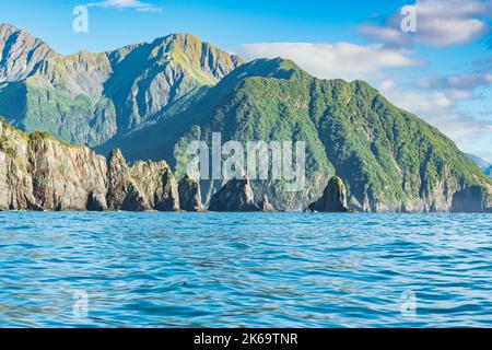 Mountains and sea stacks along the rugged coastline of Resurrection Bay near Seward, Alaska Stock Photo