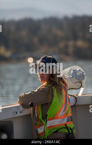 Female security officer in a safety vest standing at the BC Ferries ship. Professional Woman Working on the ship. Travel photo, editorial-October 2,20 Stock Photo