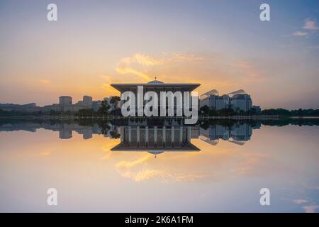 Mirror reflection of beautiful Iron Mosque during blue hour Stock Photo