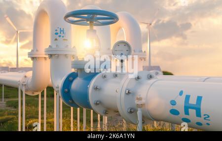 Hydrogen pipeline with manometer and wind turbines power plants in the background at sunset. Hydrogen Zero Emission energy storage concept image Stock Photo