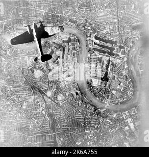 A German Luftwaffe Heinkel He 111 bomber flying over the East End during World War II. Stock Photo