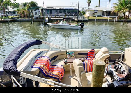 Deck of boat docked along the Canals busy with partying boaters near Phuzzy's Boat Shack restaurant & locals bar dock, St. James City, Pine Island, FL Stock Photo