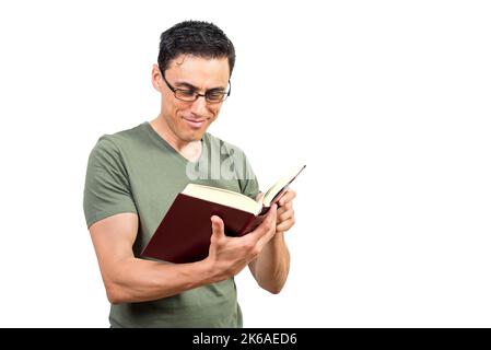 Smiling clever man in eyeglasses reading book Stock Photo