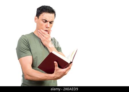 Thoughtful man touching chin and reading book Stock Photo