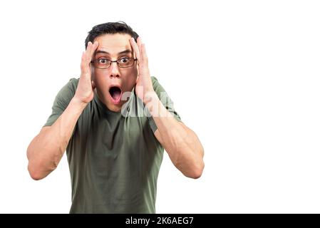 Shocked male nerd in glasses looking at camera Stock Photo