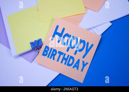 Happy Birthday. Text on adhesive note paper. Event, celebration reminder message. Stock Photo