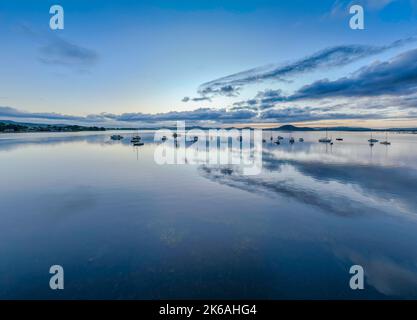 Sunrise reflections over Brisbane Water at Koolewong and Tascott on the Central Coast, NSW, Australia. Stock Photo