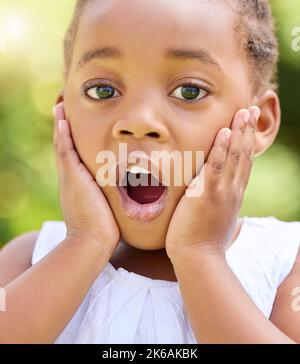 What a surprise. a little girl looking surprised in nature. Stock Photo