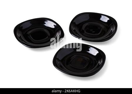 Three black ceramic saucers isolated on white Stock Photo