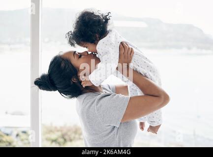 My whole heart is hers. a mother holding her baby daughter at home. Stock Photo