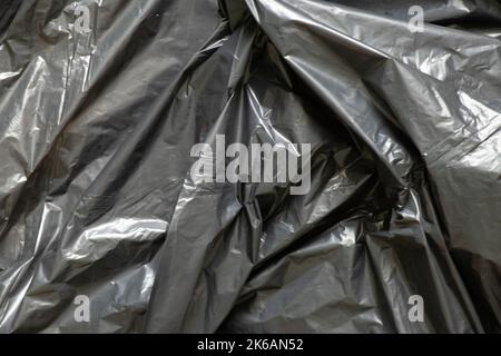 Black wrinkled film as a background, black package for backgrounds Stock Photo