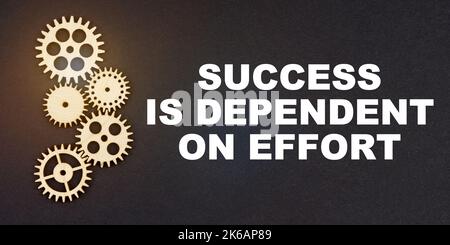 Business and industry concept. On a black background, gears and the inscription - SUCCESS IS DEPENDENT ON EFFORT Stock Photo