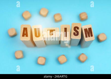 Medicine concept. On a blue background, wooden cubes and Jenga with the inscription - AUTISM Stock Photo