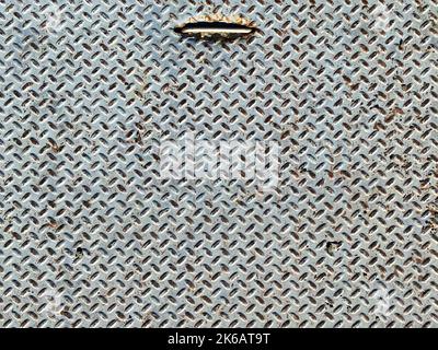 a rusted diamond plate steel door lid iron ridged ship floor trapdoor hatch metal rusty industrial background old industry rust handle backdrop Stock Photo