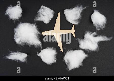 Transport and weather concept. The plane is flying among the clouds. Isolated on black background. Stock Photo