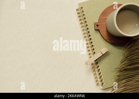 Green notebook and cup of coffee on table. flat lay, top view, copy space Stock Photo