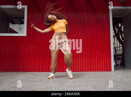 City, hip hop dance and an urban black woman in streetwear dancing outside in Sao Paulo. Music, dancer and a cool happy latino girl with outdoor Stock Photo