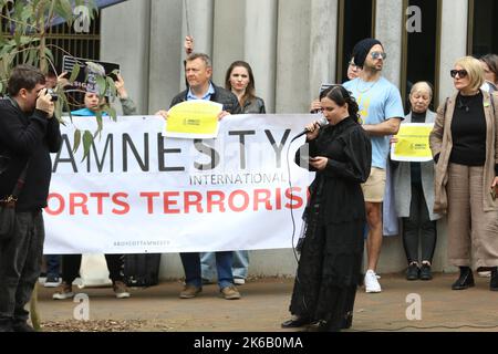 Sydney, Australia. 13th October 2022. Ukrainians and their supporters protested across the street from the Sydney office of Amnesty International at 79 Myrtle Street, Chippendale as they accuse them of spreading Russian propaganda and trying to discredit the Armed Forces of Ukraine. Pictured: A Russian lady speaks at the protest and says she is ashamed of what her country is doing to Ukraine. Credit: Richard Milnes/Alamy Live News Stock Photo