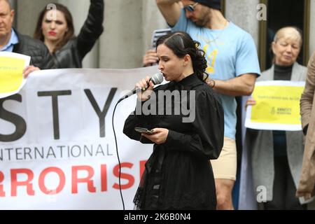 Sydney, Australia. 13th October 2022. Ukrainians and their supporters protested across the street from the Sydney office of Amnesty International at 79 Myrtle Street, Chippendale as they accuse them of spreading Russian propaganda and trying to discredit the Armed Forces of Ukraine. Pictured: A Russian lady speaks at the protest and says she is ashamed of what her country is doing to Ukraine. Credit: Richard Milnes/Alamy Live News Stock Photo