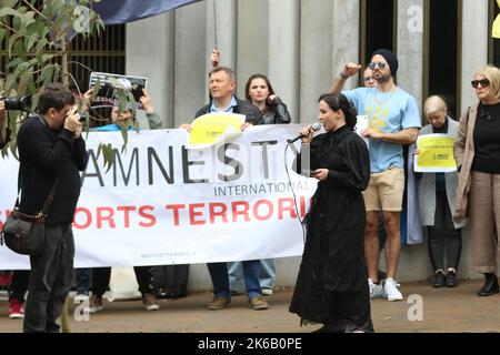 Sydney, Australia. 13th October 2022. Ukrainians and their supporters protested across the street from the Sydney office of Amnesty International at 79 Myrtle Street, Chippendale as they accuse them of spreading Russian propaganda and trying to discredit the Armed Forces of Ukraine. Pictured: A Russian lady speaks at the protest and says she is ashamed of what her country is doing to Ukraine. Credit: Richard Milnes/Alamy Live News Stock Photo