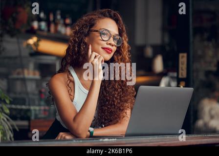 Black woman, working at cafe on laptop and remote work online as digital freelance employee. Modern professional businesswoman, writing web design Stock Photo