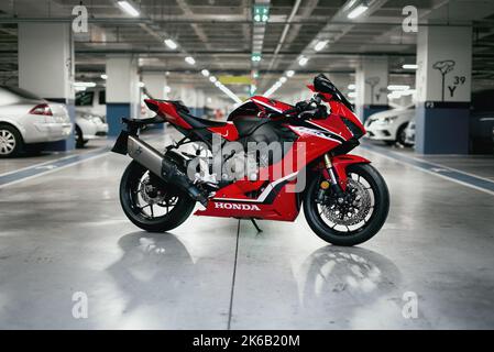 Izmir, Turkey - September 25, 2022: Side view photo of a Honda CBR 1000 RR fireblade racing motorcycle in a parking lot. Stock Photo