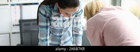 Two female architects are studying blueprint of building house Stock Photo