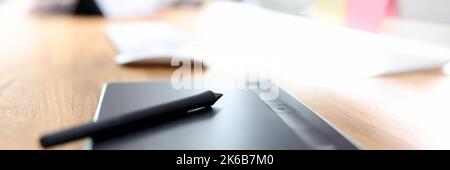 Graphic tablet and stylus on designer desktop closeup Stock Photo