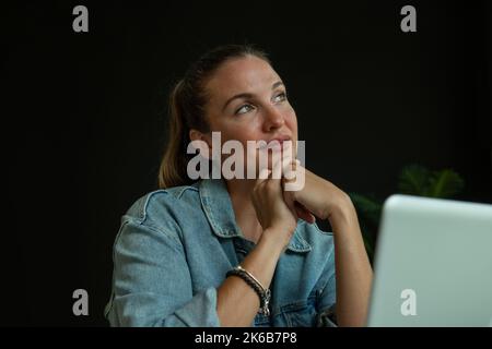 Girl working on laptop in trendy coffee shop - stock photo Stock Photo