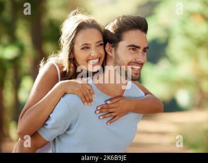 Carry me there. an affectionate couple spending time together outdoors. Stock Photo